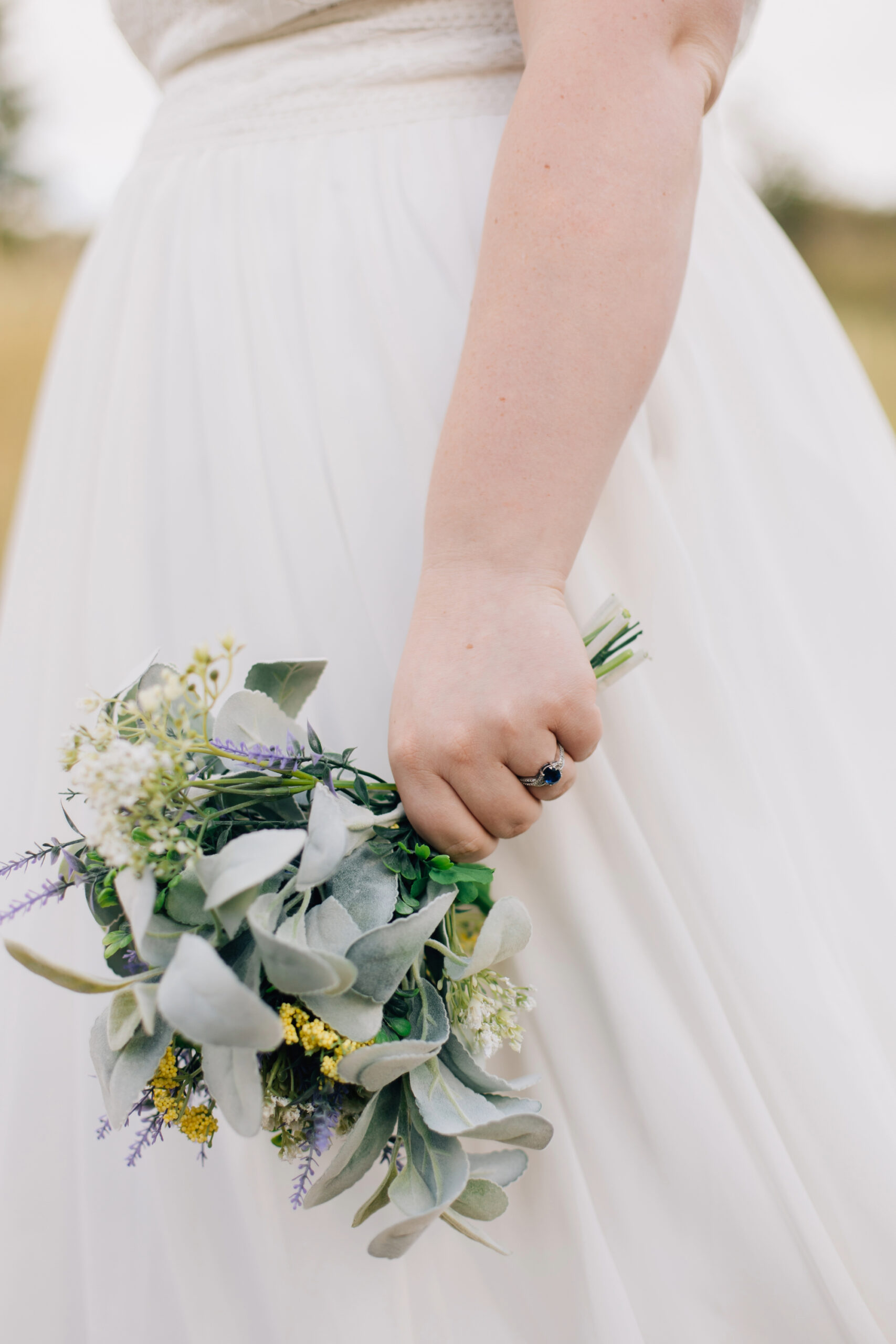 Up close ring and bouquet shot of bride