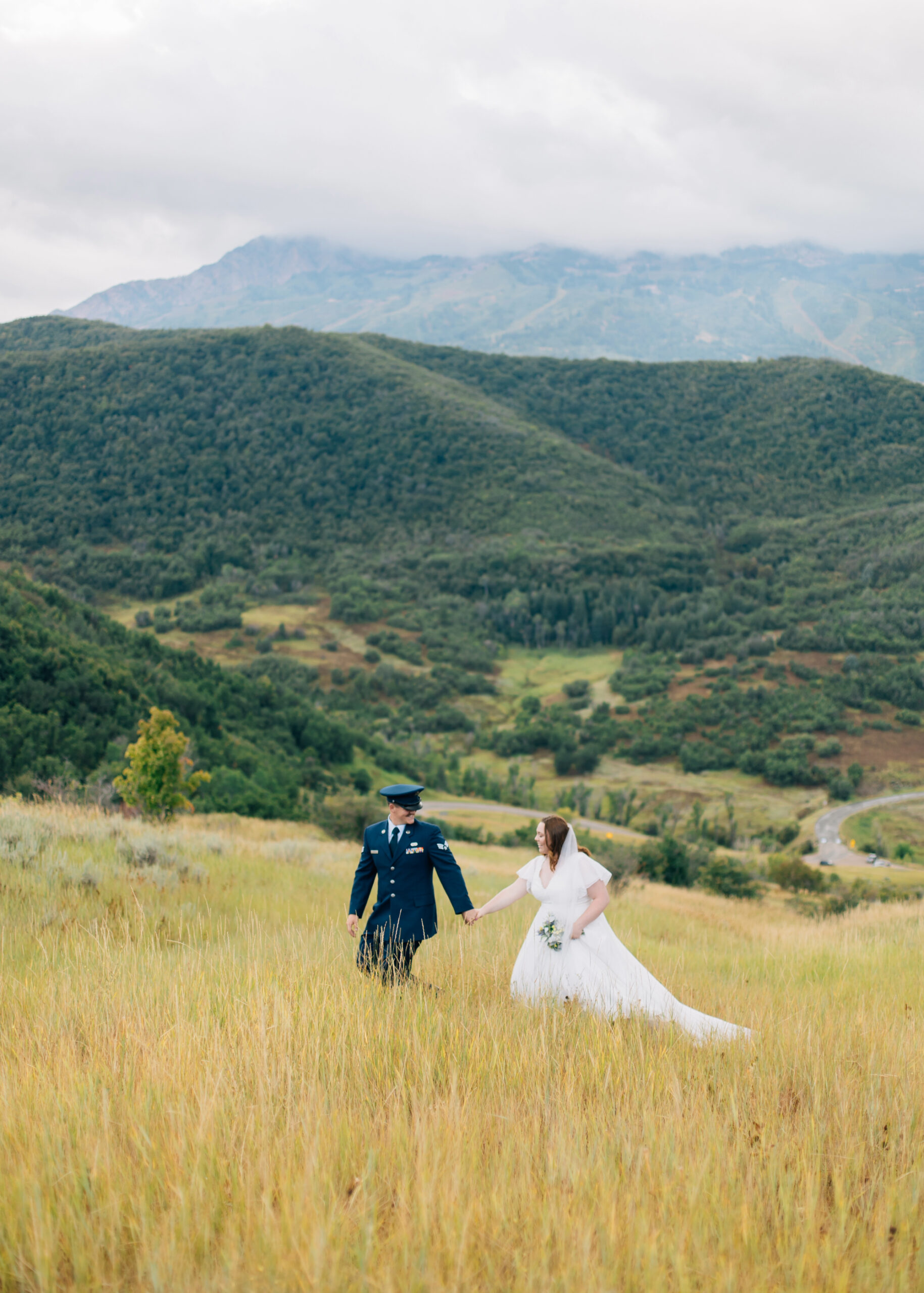 Wide shot of wedding portraits at Snowbasin with mountains