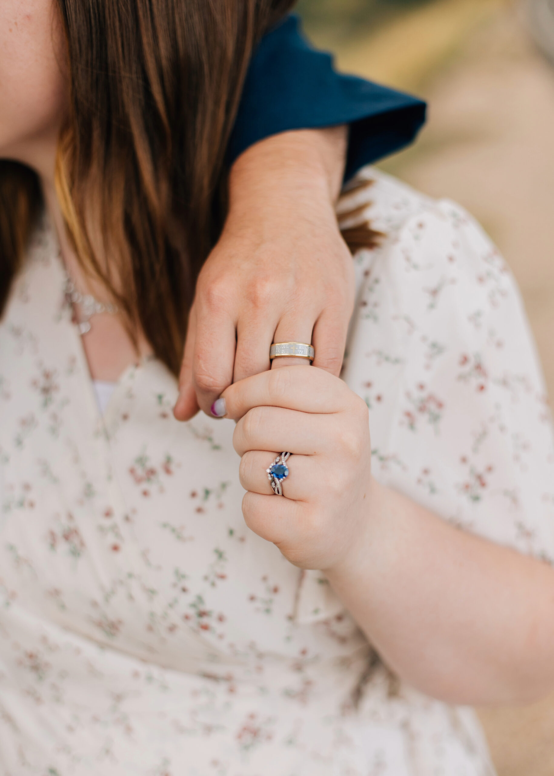 Engagement photo holding hands showing wedding rings