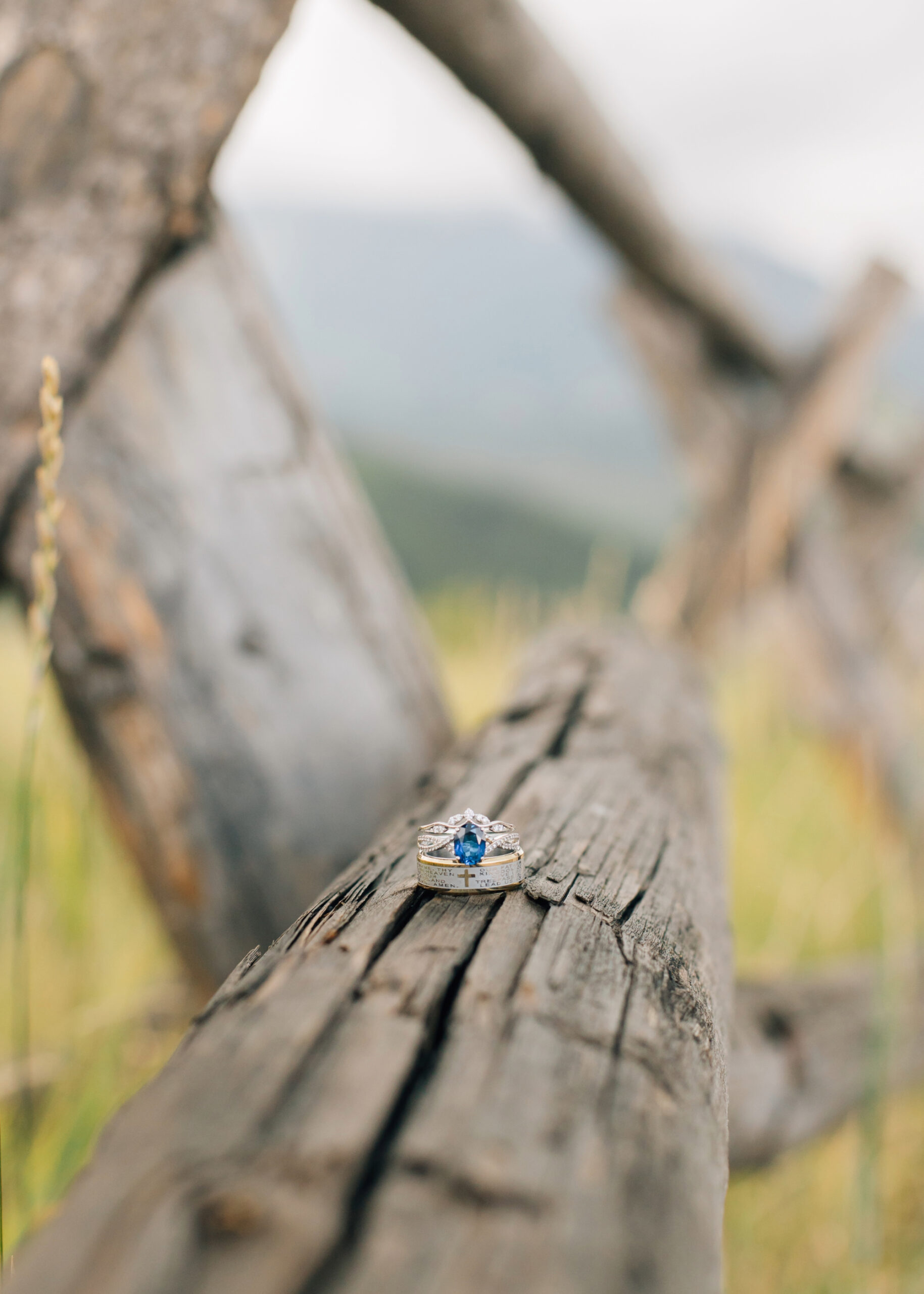 Detail shot of wedding rings on wooden fence Utah wedding photographer