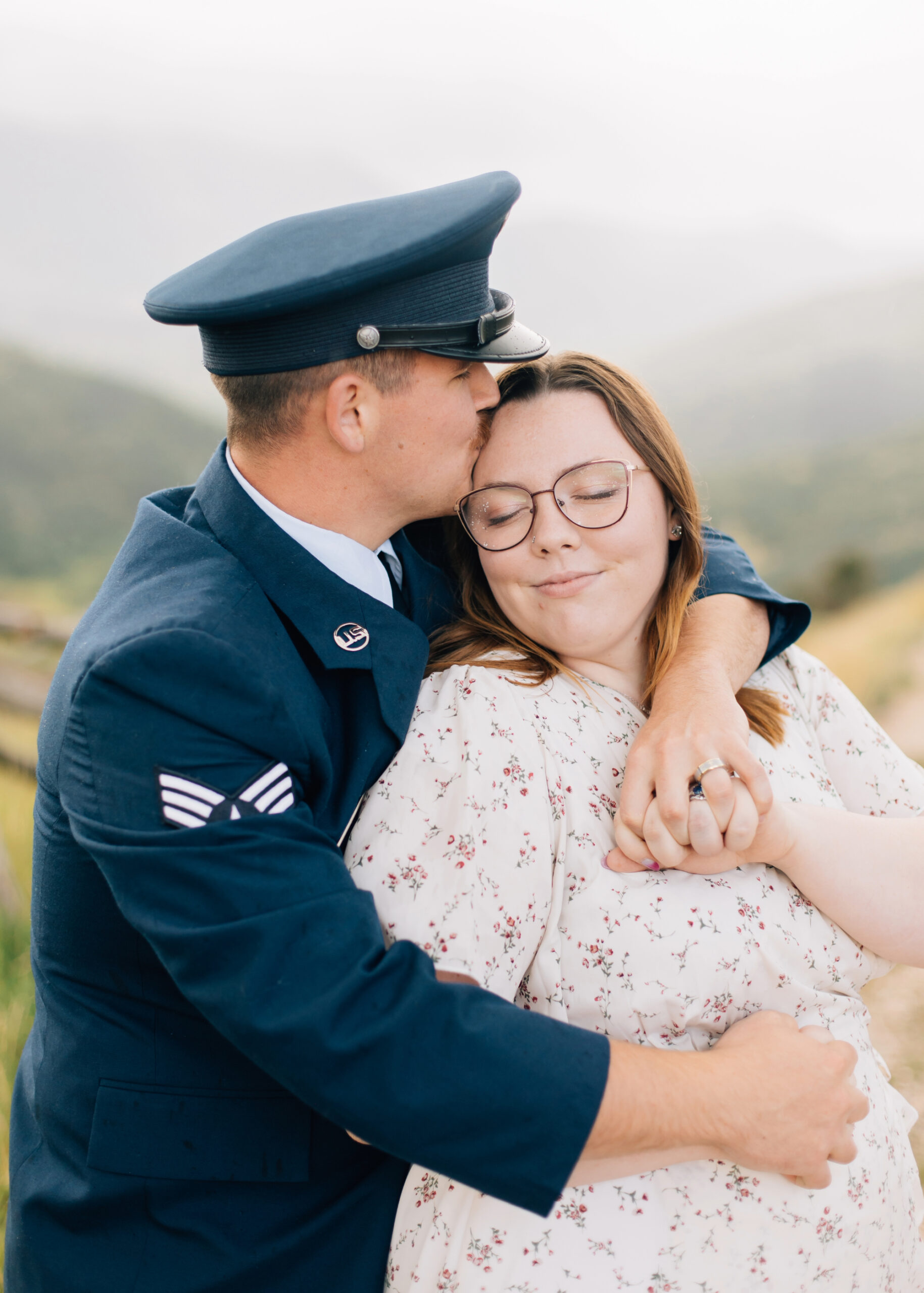 Cozy engagement photos couple snuggling and kissing forehead