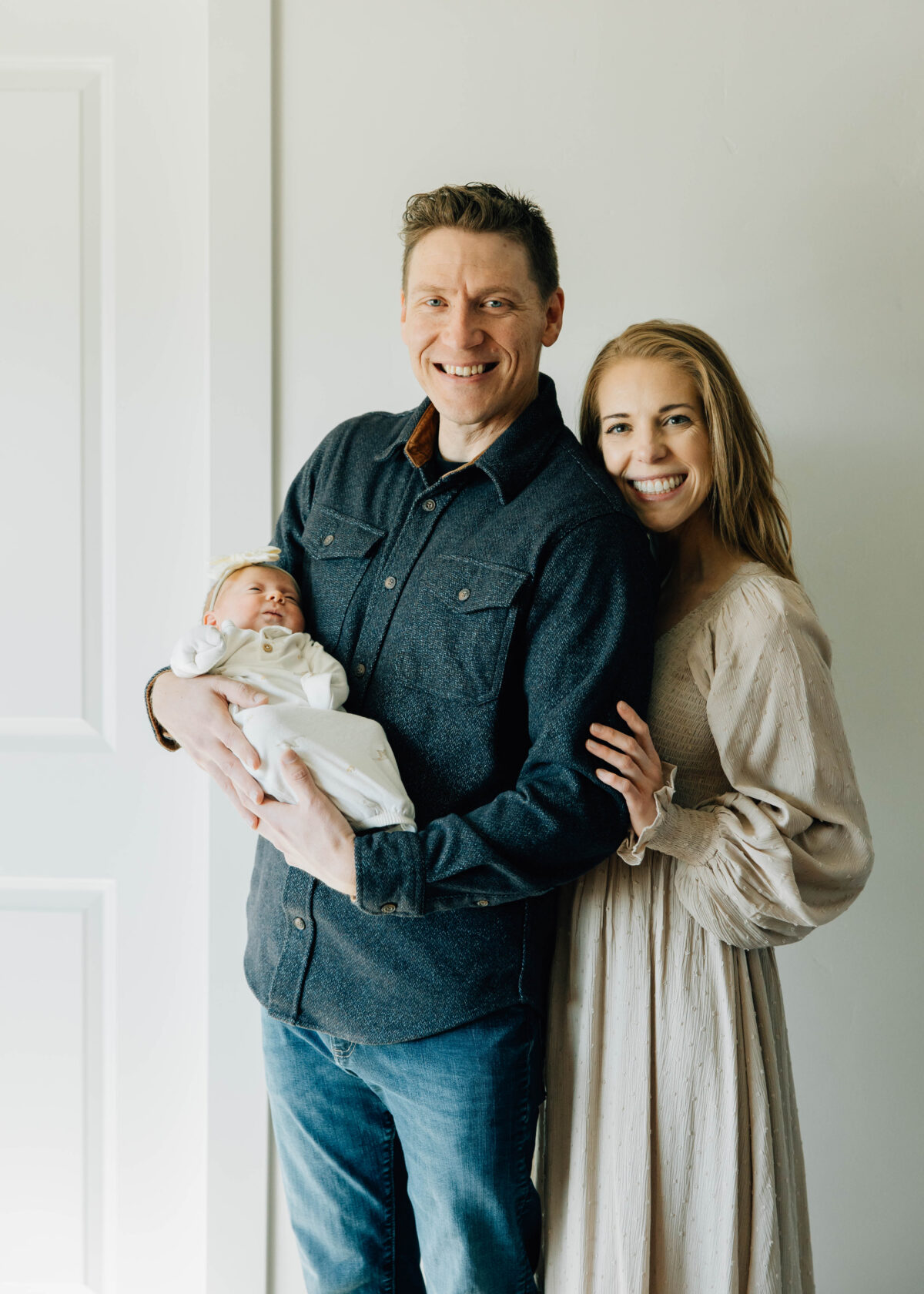 Smiling family with newborn baby